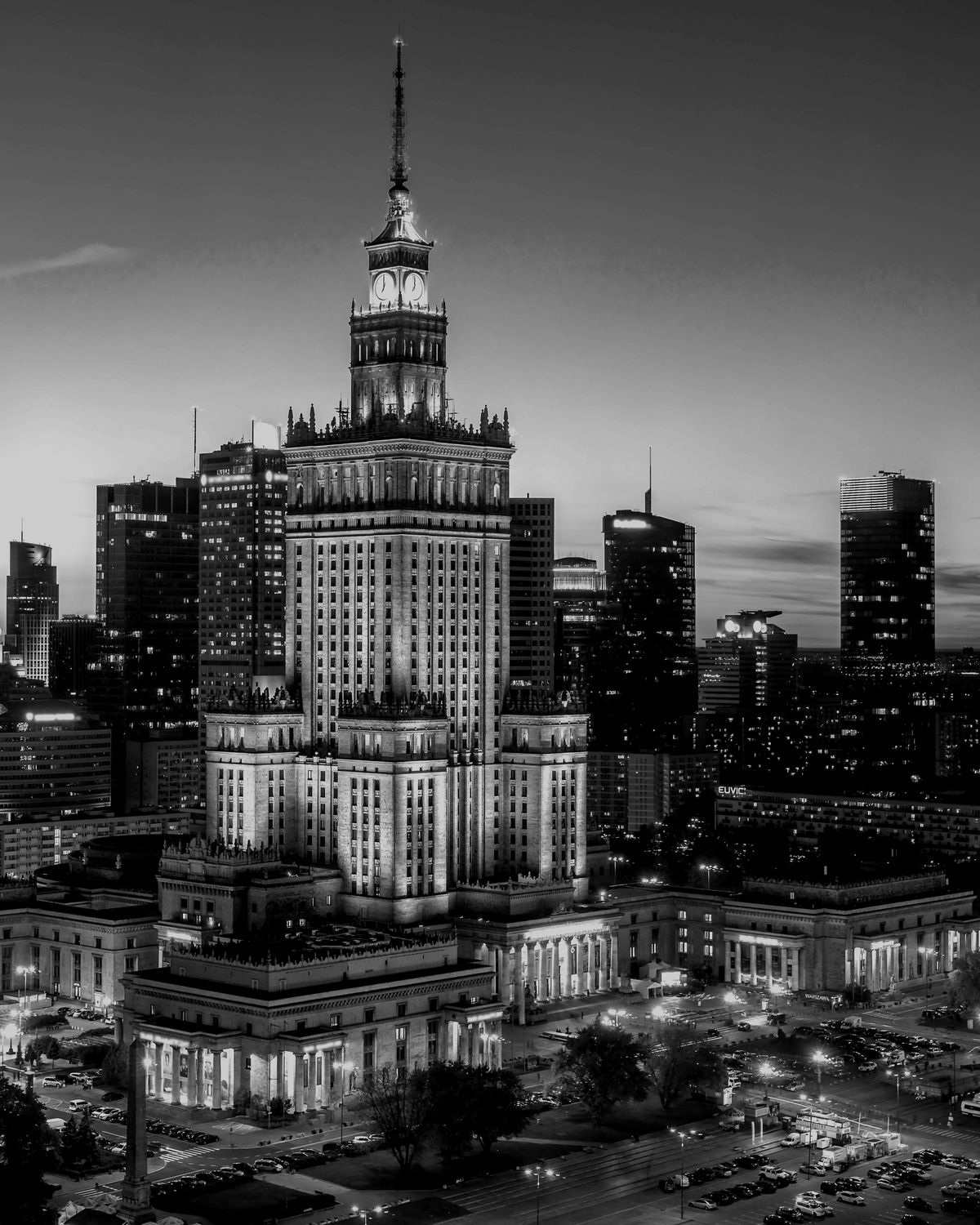 Pałac Kultury i Nauki w Warszawie otoczony wieżowcami o zmierzchu, widok z góry