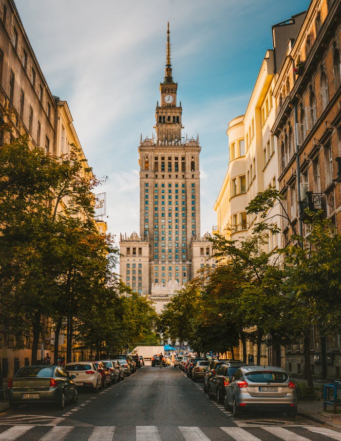 A vibrant street view of the Palace of Culture and Science in Warsaw, showcasing urban architecture.